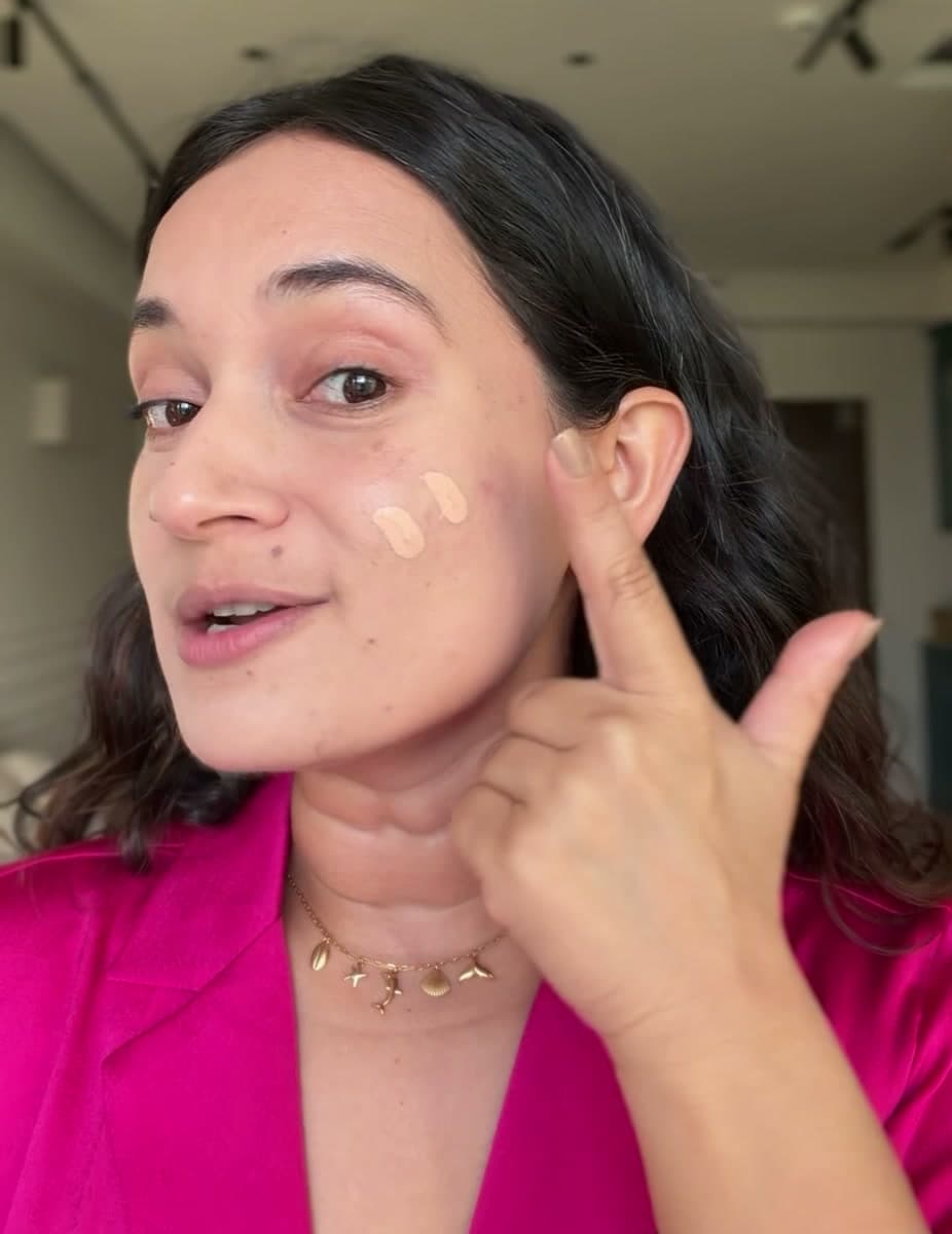 Aishwarya applying skin tint directly to her cheek
