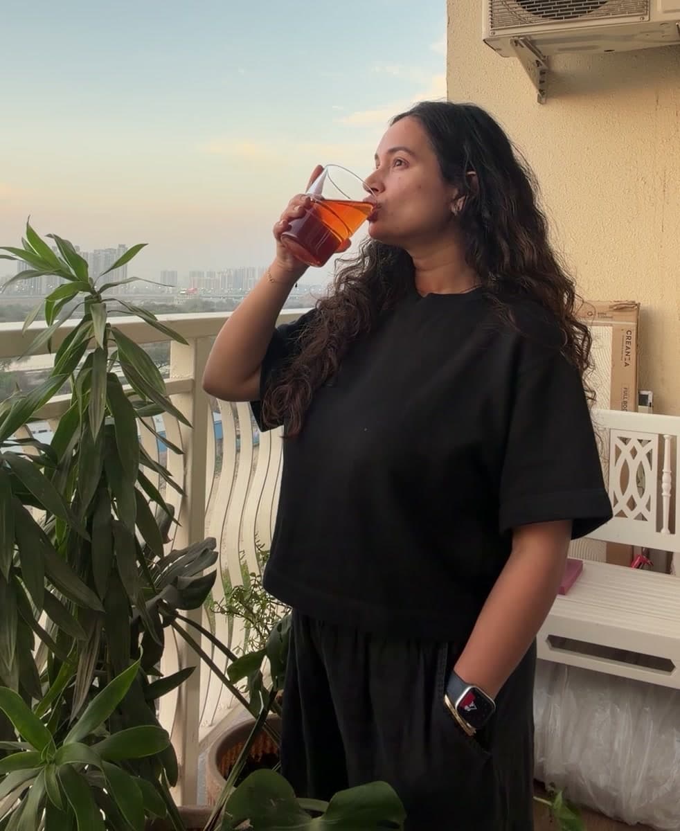 Aishwarya having a drink on her balcony at sunset